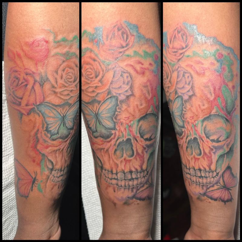 Three views of a color forearm tattoo of a skull surrounded by roses and butterflies in soft pink, orange and teal.